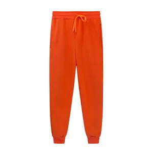 Bright orange sweatpants detail showcasing elastic drawstring waistband and ribbed cuffs.