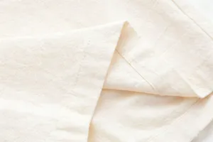 Close-up of mens casual cotton linen shorts fabric texture and neat stitching details.