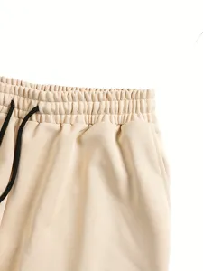 Detail view of casual shorts featuring an elastic drawstring waistband in solid beige color.