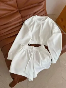 Minimalist white crewneck long sleeve sweatshirt and drawstring shorts lounge set detail view