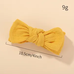 Detailed view of yellow bow kids headband with size and weight measurements