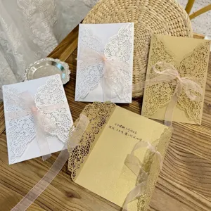 Vue détaillée d'invitations découpées au laser avec des rubans roses