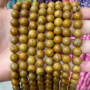 Detailed macro view of natural earth-toned jasper round beads with wood-grain patterns