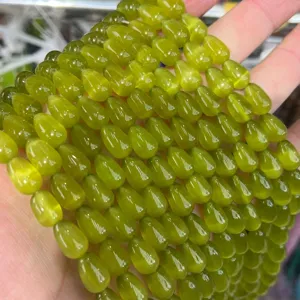 Close-up macro view of 8x12mm green teardrop cat's eye beads for handmade jewelry DIY