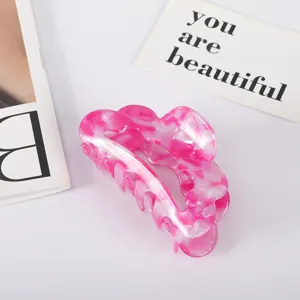 Pink marbled acetate hair claw clip with fan-shaped design for hair styling