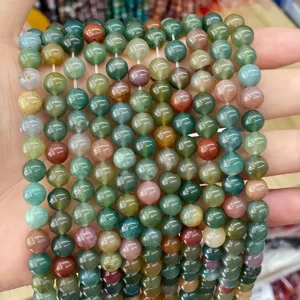 Macro view of colorful natural agate and chalcedony round beads for DIY jewelry making.