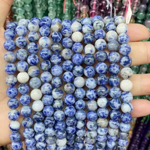 Macro detail view of blue and white natural stone beads for DIY jewelry making crafts.
