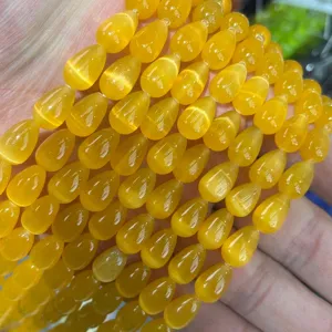 Macro view of 8x12mm yellow cat's eye teardrop beads for jewelry making