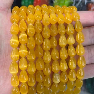 Macro view showing 8x12mm yellow cat eye teardrop beads with bright optical chatoyancy