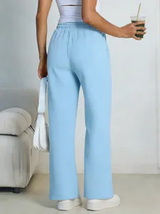 Detailed back view of women light blue loose wide leg sweatpants with high waist and drawstring.