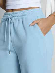 Light blue casual sweatpants detail shot, comfortable loose drawstring trousers for women daily wear.
