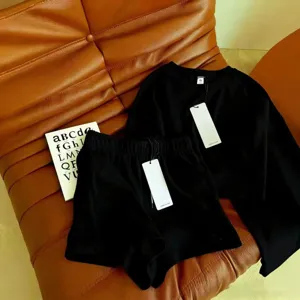 Detailed view of black sweatshirt and shorts set, premium fabric and clean minimalist design.