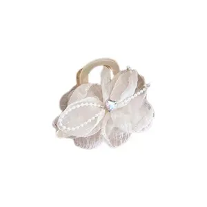 Exquisite white fabric flower hair claw detail with pearl chain and rhinestone heart.