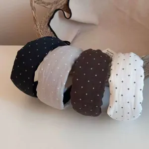 Detailed view of stylish wide fabric headbands featuring cute star prints in four chic colors.