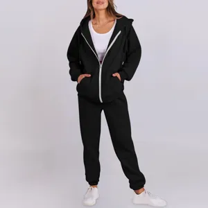 Detailed view of black fleece zip hoodie and sweatpants set, highlighting soft fabric and zipper.