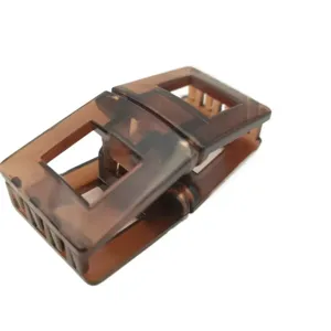 Close-up detail of the brown square magnetic hair clip featuring a hollow geometric design.