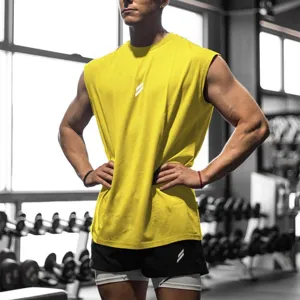 Detailed view of men's breathable yellow sleeveless gym tank top in a modern fitness studio.