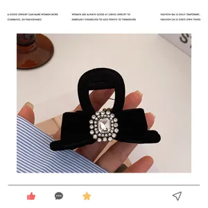 Elegant black velvet hair claw clip featuring sparkling rhinestone bow design for women chic styling.