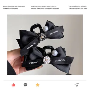 Elegant pearl camellia bow hair claw clip for women, stylish black satin hair accessories.