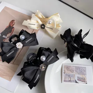 Elegant camellia bow hair claw clips with pearls, chic satin shark clip hair accessories set.