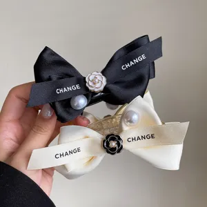 Black white ribbon pearl camellia hair claw clip detail view for elegant women daily styling.