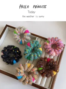 Detailed view of colorful plush telephone wire hair ties with fluffy balls, soft and high elastic.