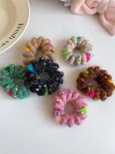 Detailed closeup view of colorful plush telephone wire hair ties with a soft fuzzy finish.