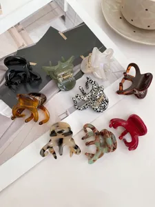 Detailed view of assorted medium acetate hair claw clips in various colors, stylish and practical.