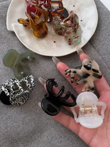 Detail view of stylish medium octopus hair claws in assorted colors and patterns, secure grip.