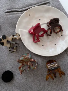 Close-up view of elegant acetate octopus hair claw clips in various tortoiseshell colors.