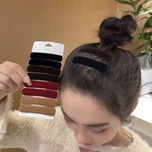 Velvet hair clip detail showing multi-color options and secure wearing on hair bun easily.