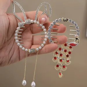Detail view of rhinestone and pearl hair claw clips, featuring cute rabbit and peacock designs.