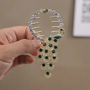 Sparkling rhinestone peacock hair claw clip for elegant buns and ponytails, detail shot.