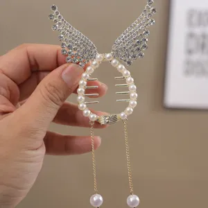 Close-up detail of the elegant pearl and rhinestone angel wings hair claw clip with tassels.