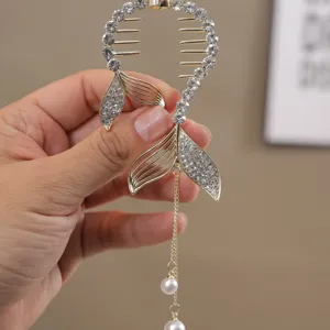Gleaming rhinestone fish tail hair claw clip with elegant pearl tassel for stylish ponytails.
