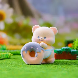 Cute flocked bear figurine detail shot, miniature grass desktop decor toy, soft touch.