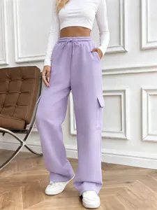 Detail view of casual purple cargo sweatpants with drawstring waist and deep pockets.