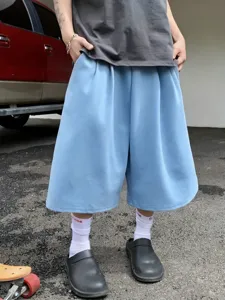 Close-up of casual light blue wide-leg culottes, loose summer shorts fit with streetwear vibe.