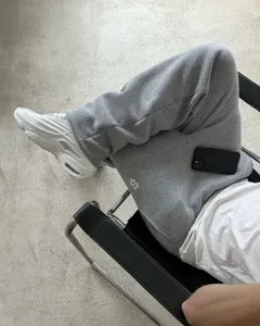 Detail view of casual grey streetwear sweatpants with embroidery, comfortable fit for daily wear.