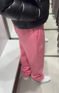 Pink streetwear embroidered sweatpants detail view, casual loose hip hop pants for men women.