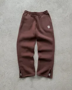 Brown streetwear sweatpants with ankle zippers and white embroidered logo for men and women.