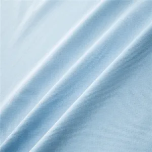 Light blue polo shirt breathable mesh fabric texture close-up, soft knit material detail