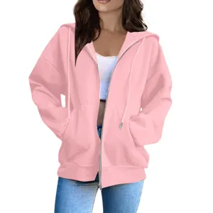 Pink zip-up hoodie detail view showcasing casual oversized fit, drawstring hood and pockets.