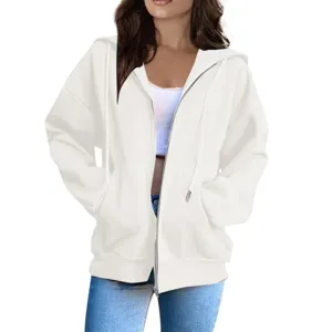 Close-up detail of the white zip-up hoodie featuring long sleeves, hood, and front pockets.