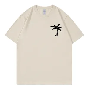 Beige short sleeve crewneck t-shirt featuring a black palm tree graphic print for women.
