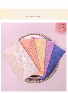 Macro detail of laser-cut butterfly lace patterns on colorful invitation cards