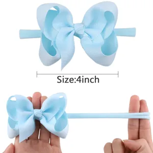 Detail of light blue 4 inch ribbon bow nylon headband showing stretchability for babies