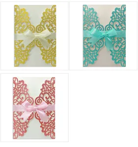 Detailed close-up showing laser cut glitter invitation cards with satin bow decorations