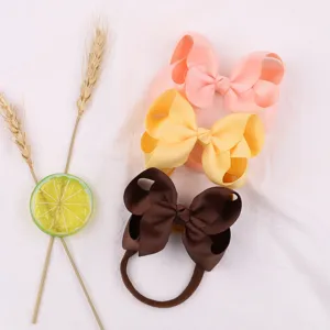 Macro view of three colorful grosgrain ribbon bows for baby headbands and hair accessories.