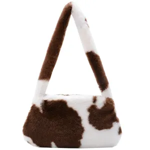 Plush faux fur underarm shoulder bag featuring a vintage brown cow print pattern